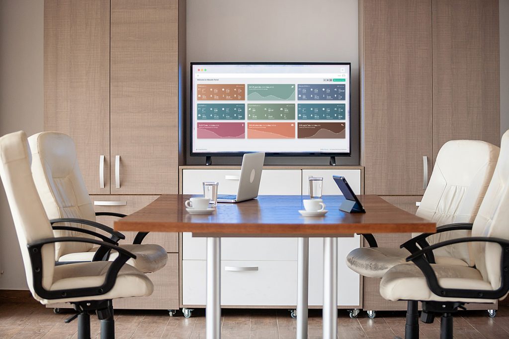Empty business meeting conference room with graphs and diagrams on TV